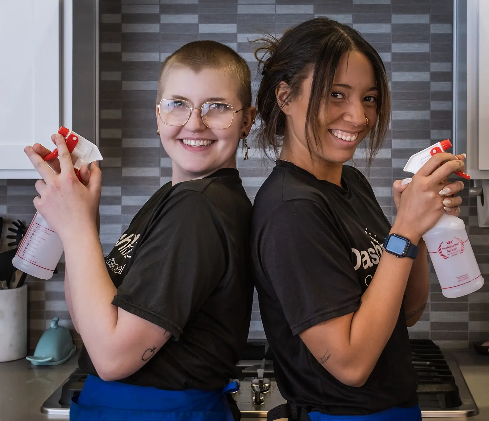 Two smiling Dashing Maids cleaners in branded shirts